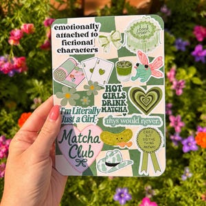 May include: A rectangular sticker sheet with a green and white checkered background featuring various illustrations including a frog, a cowboy hat, a pickle, playing cards, a matcha drink, and text reading "emotionally attached to fictional characters" and "Matcha Club".