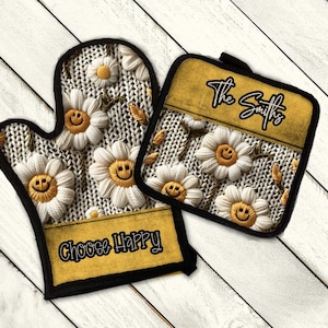 May include: A set of two yellow and white oven mitts with a knitted pattern and smiling daisy flowers. The text "Choose Happy" is on the larger mitt and "The Smiths" is on the smaller mitt.