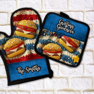 May include: A set of two blue and red striped oven mitts with a burger design. The oven mitt has the text "The Smiths" on the bottom. The pot holder has the text "Grilling Goodness" on the top.