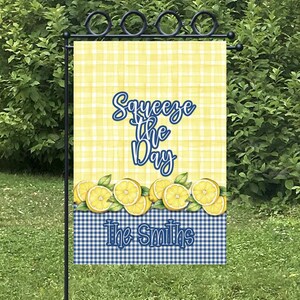 May include: Yellow and blue gingham garden flag with lemons and the text "Squeeze the Day" and "The Smiths".