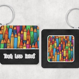 May include: A colourful keychain with a black background and the text "Teach Love Repeat". The keychain features a pattern of colourful pencils.