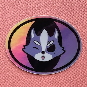 May include: A purple and blue cartoon wolf with a black eye patch and its tongue sticking out. The wolf is inside a circle with a pink and yellow gradient background.