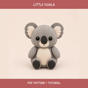 May include: A felt koala plush toy featuring grey and cream-colored fabric with visible stitching. The koala has black eyes, a dark grey nose, and a cream belly. The text "LITTLE KOALA" and "PDF PATTERN + TUTORIAL" is displayed in white.