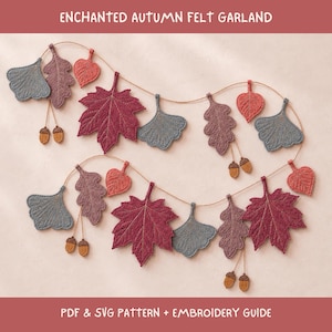 May include: An enchanted autumn felt garland featuring embroidered leaves and acorns in shades of burgundy, dusty rose, and slate blue. The garland includes maple, oak, and ginkgo leaf shapes strung on a thin cord. Text reads: ENCHANTED AUTUMN FELT GARLAND PDF & SVG PATTERN + EMBROIDERY GUIDE.