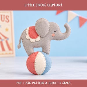 May include: A felt craft project featuring a grey elephant standing on a red, white, and blue ball. The elephant has a scalloped red and white saddle, closed eyes, and a pink cheek. Text at the top reads LITTLE CIRCUS ELEPHANT and at the bottom PDF + SVG PATTERN & GUIDE | 2 SIZES.
