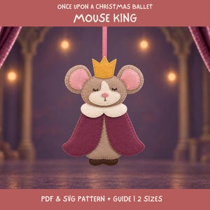 May include: A felt mouse king ornament featuring a yellow crown, pink-lined ears, and a deep purple cape. The text reads: ONCE UPON A CHRISTMAS BALLET MOUSE KING. Below, the text reads: PDF & SVG PATTERN + GUIDE | 2 SIZES. The mouse has closed eyes.