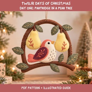 May include: A felt ornament featuring a brown branch arch with green leaves, two yellow pears, and a central bird with a pink and purple wing. The text reads: TWELVE DAYS OF CHRISTMAS DAY ONE: PARTRIDGE IN A PEAR TREE. PDF PATTERN + ILLUSTRATED GUIDE.