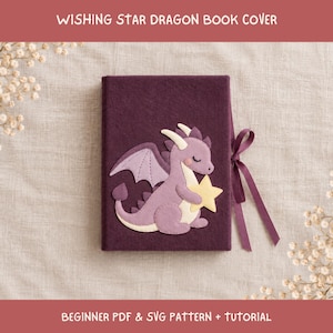 May include: A dark purple felt book cover featuring a light purple dragon appliqué holding a yellow star. The cover includes a matching purple ribbon tie on the right side. The text WISHING STAR DRAGON BOOK COVER and BEGINNER PDF & SVG PATTERN + TUTORIAL is visible.