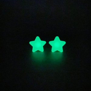 May include: Two green glow-in-the-dark star-shaped earrings.