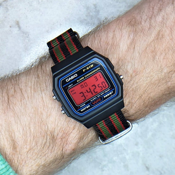 Casio F-91 Watch (Light Blue) on an Orange Nylon Strap