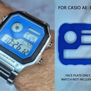 May include: A digital watch with a blue face and silver band displays the time 10:26:12. The watch is labeled "ILLUMINATOR". Beside it is a blue face plate with cutouts. Text reads "FOR CASIO AE-1200" and "FACE PLATE ONLY, WATCH NOT INCLUDED."