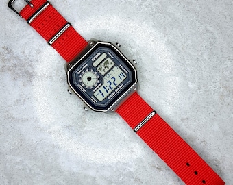 Casio World Time Illuminator Silver Watch with Red nylon Band, AE-1200WHD-1AVEF