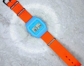 Casio F-91 Watch (Light Blue) on an Orange nylon wrap-around Strap, F-91WC-2AEF