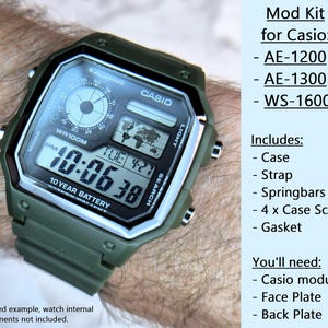 May include: An olive green Casio watch mod kit, including a case, strap, springbars, screws, and gasket. The watch face displays the time, date, and other functions. Text on the image reads "Mod Kit for Casio" and lists compatible models.