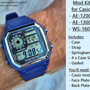 May include: A blue Casio watch mod kit, including a case, strap, springbars, screws, and gasket. The watch face displays the time, date, and other functions. The text on the watch face reads "CASIO" and "WR100M".