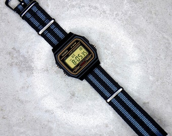 Casio F-91 Watch with Black and Grey James Bond Nylon Strap (Gold detail dial). Option to add a Screen Colour mod, 8 colours to choose from