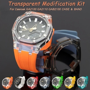 May include: Transparent modification kit for Casioak GA2100 watches. The image shows a clear case and band with an orange strap. Several other watch bands in various colors are displayed below, including white, red, blue, green, yellow, and teal.
