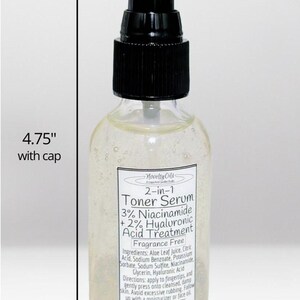 May include: A clear glass bottle containing a 2-in-1 Toner Serum with a black pump cap. The label reads 2-in-1 Toner Serum, 3% Niacinamide + 2% Hyaluronic Acid Treatment. The bottle measures 4.75 inches in height with the cap and 1.75 inches in width.