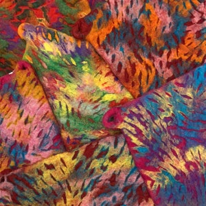 May include: A collection of colorful felt squares with a tie-dye pattern. The squares are arranged in a pile, with the top square being a vibrant orange and red.