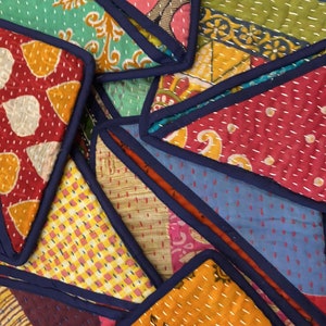 May include: A collection of colorful fabric coasters with intricate patterns and a dark blue trim. The coasters are made of patchwork fabric and are perfect for adding a touch of bohemian style to your home.