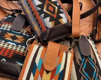 May include: Four small crossbody bags with colorful geometric patterns and brown leather accents. The bags have adjustable straps and are perfect for carrying essentials.