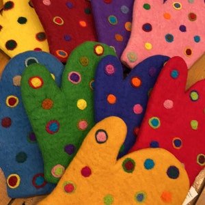 May include: A set of ten colorful oven mitts with a polka dot pattern. The mitts are made of felt and have a variety of colors, including yellow, red, green, blue, and purple.