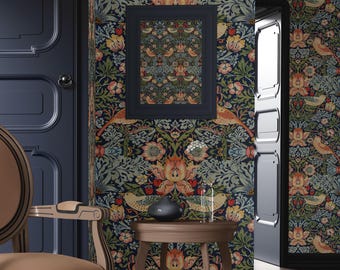 May include: A dark blue room with a floral wallpaper featuring birds and flowers. A framed print with a similar design hangs on the wall. A brown wooden side table with a black vase sits in front of the wallpaper. A brown chair with a black trim sits in the foreground.