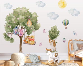 May include: A wall decal set featuring watercolor illustrations of Winnie the Pooh characters including Eeyore, Piglet, Tigger, and Owl. The design includes a large tree with a beehive, a swing, a hot air balloon, clouds, a sun, and butterflies.