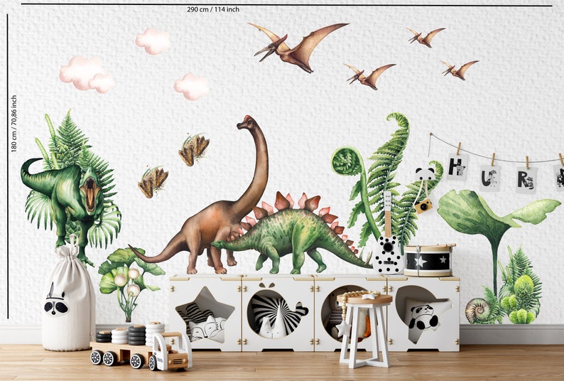 May include: A whimsical wall mural featuring watercolor dinosaurs, pterodactyls, and clouds. The design includes a Stegosaurus, Brachiosaurus, and a T-Rex, along with ferns and a wooden toy truck. The mural measures 114 inches wide and 70.86 inches high.