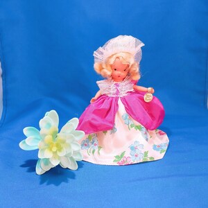 Vintage Nancy Ann storybook doll, 1940s series collectible, dressed in a floral silk gown and net bonnet
