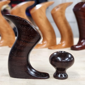 May include: Two dark brown wooden handles for a woodworking tool. The larger handle is curved and the smaller handle is round.