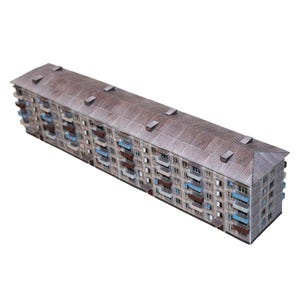Op de afbeelding: Een gedetailleerd miniatuurmodel van een lang appartementencomplex. Het gebouw heeft een verweerde, grijze gevel met talrijke ramen en balkons. Het dak is roestbruin en de balkons zijn blauw geschilderd. Het ontwerp suggereert een vintage of retro esthetiek.