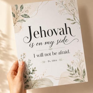 May include: A rectangular white print featuring the black text 'Jehovah is on my side I will not be afraid. Ps. 118:6' centered on the page. The design is decorated with watercolor-style green leaves, thin stems, and soft beige abstract shapes.