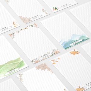 Op de afbeelding: Witte gelijnde notitieblokken met bloemen- en aquarelontwerpen. Elk notitieblok heeft een zoekbalkafbeelding met de tekst "Visit, Pin and Search, Enjoy Life Forever". De notitieblokken hebben verschillende bloemen- en landschapsaquarel hoekontwerpen.