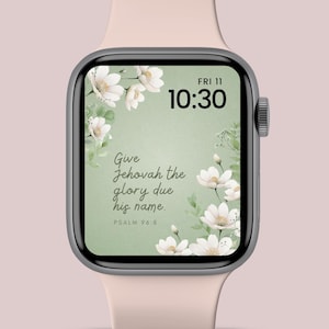 May include: A silver smartwatch with a pale pink strap shows a floral wallpaper with white flowers and green leaves. The screen displays the time, date, and the text "Give Jehovah the glory due his name. Psalm 96:8."