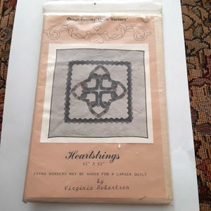 May include: A vintage quilt pattern for a Heartstrings quilt, measuring 65 inches by 65 inches. The pattern features a design of interlocking hearts and is by Virginia Robertson.