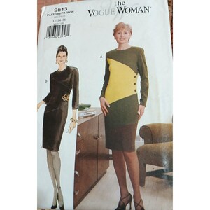 May include: A Vogue Woman sewing pattern envelope 9513 featuring two dress designs. View A is a long-sleeved color-blocked dress in olive, yellow, and brown with side buttons. View B is a solid dark brown long-sleeved dress with a decorative side accent.