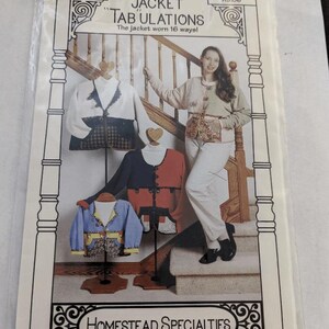 May include: A package for a sewing pattern titled "JACKET TABULATIONS" with the text "The jacket worn 16 ways!" The package shows a woman and three jacket designs on mannequins. The brand name "HOMESTEAD SPECIALTIES" is at the bottom.