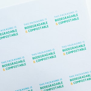 May include: A sheet of white paper with multiple round stickers that say "This packaging is biodegradable & compostable" in green and yellow text.