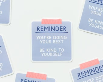 May include: Light blue reminder stickers with the text "REMINDER", "YOU'RE DOING YOUR BEST", and "BE KIND TO YOURSELF". The stickers are rectangular with rounded corners and are affixed with pink tape.