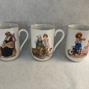 Norman Rockwell mugs from the Rockwell museum gold trimmed