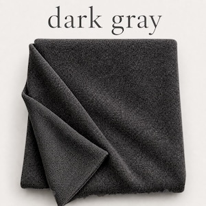 May include: A square piece of dark gray fabric with a visible textured knit pattern. The fabric is folded over at one corner, revealing the underside of the material. The text "dark gray" is printed in a simple font above the fabric.