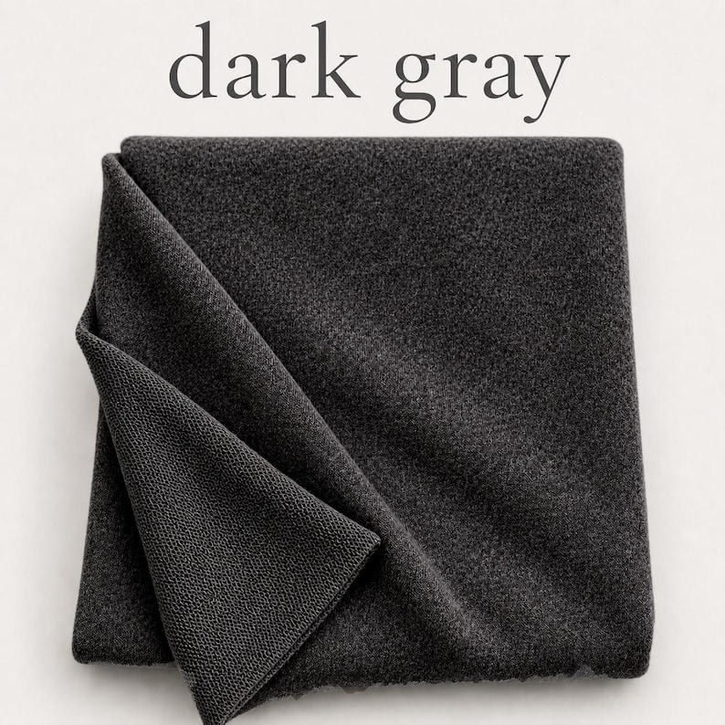 May include: A square piece of dark gray fabric with a visible textured knit pattern. The fabric is folded over at one corner, revealing the underside of the material. The text "dark gray" is printed in a simple font above the fabric.