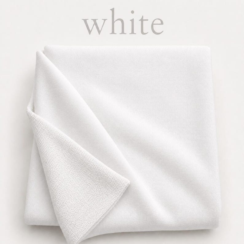 May include: A folded square of solid white fabric with a visible knit texture. The top corner is turned over to reveal the reverse side of the material. The word white is printed in a light gray serif font above the folded textile.
