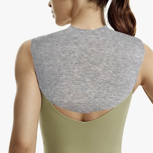 May include: A grey sleeveless shirt with a scoop neck and a back cutout. The shirt is made of a soft, breathable fabric and is perfect for layering.