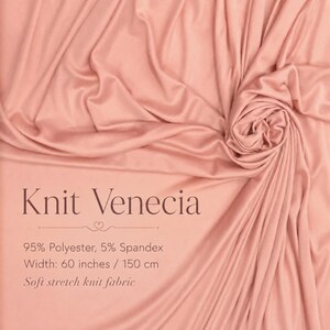 May include: A soft, solid peach-coloured stretch knit fabric with folds and drapes. Text on the fabric reads: Knit Venecia, 95% Polyester, 5% Spandex, Width: 60 inches / 150 cm, Soft stretch knit fabric. The material has a smooth, matte appearance.