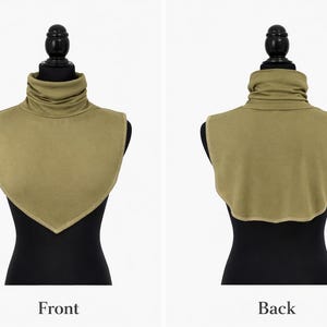 May include: Olive green turtleneck collar, displayed on a black mannequin. The front view has a pointed bottom, the back view has a rounded edge. The fabric appears soft, offering a versatile accessory for various outfits.