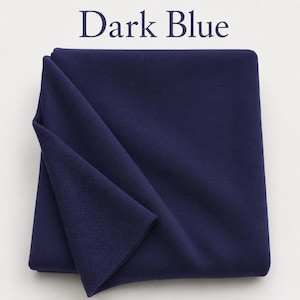 May include: A folded piece of dark blue fabric with a smooth, matte surface on one side and a textured, knit-like appearance on the underside. The text "Dark Blue" is printed in a dark blue serif font above the fabric.