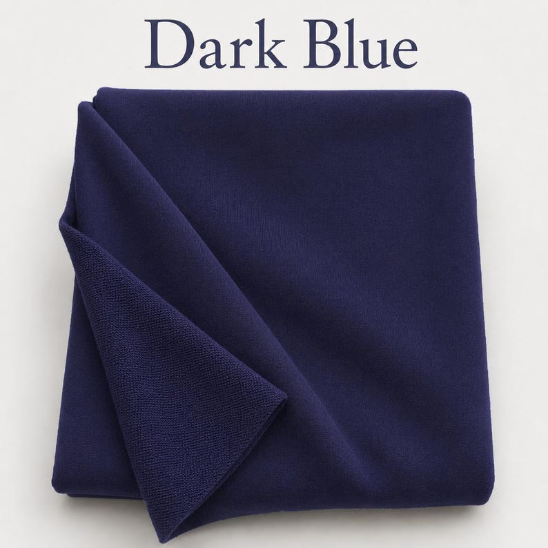 May include: A folded piece of dark blue fabric with a smooth, matte surface on one side and a textured, knit-like appearance on the underside. The text "Dark Blue" is printed in a dark blue serif font above the fabric.