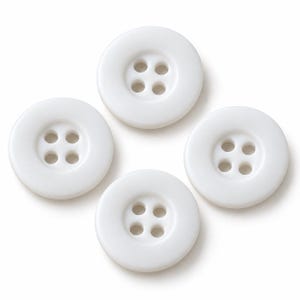 May include: Four circular white buttons arranged in a diamond pattern. Each button features a smooth, matte surface with a slightly raised outer rim and four evenly spaced holes in the center for sewing attachment, presented against a plain background.